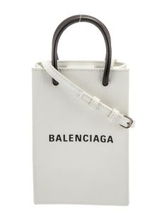 Balenciaga Shoulder BagFrom the Spring/Summer 2020 Collection by Demna GvasaliaWhite LeatherGraphic PrintGold-Tone HardwareRolled Handles & Single Adjustable Shoulder StrapCanvas LiningSnap Closure at TopIncludes Box & Dust BagUnfortunately, due to restrictions, this item may not be eligible for shipping in all areas. Chic Spring Bags With Logo, Casual Logo Bags For Spring, Casual Summer Bags With Logo, Trendy Summer Bags With Logo, White Leather Summer Bag, White Leather Bag For Summer, Balenciaga Logo, Coach Horse And Carriage Tote, Name Logo