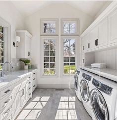 a washer and dryer in a large white kitchen