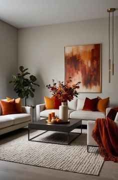 a living room filled with furniture and a large painting on the wall above it's coffee table