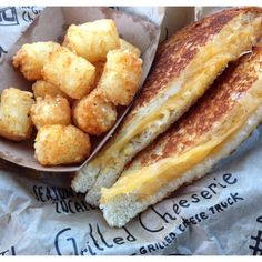 a grilled cheese sandwich and tater tots are on the wrapper next to each other