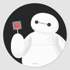 a round sticker with a white robot holding a red object in it's hand