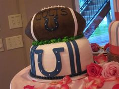 a football themed cake with flowers on the table