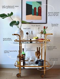 a gold bar cart with drinks on it and labeled parts to make the perfect bar cart