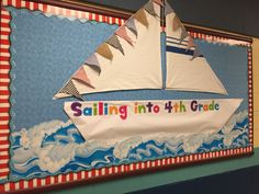 a sailboat made out of paper on a bulletin board that says sailing into 4th grade