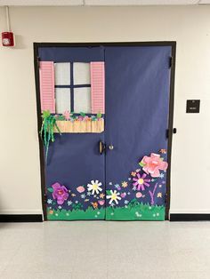 a door decorated with paper flowers and pink shutters in a school hallway or classroom room