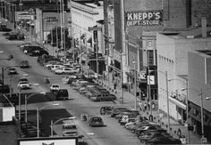 an old black and white photo of cars on a city street