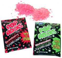 two bags of pink candy sitting next to each other on a white surface with stars around them