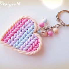 a pink, blue and white knitted heart shaped keychain