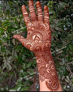 the hand is decorated with henna on it