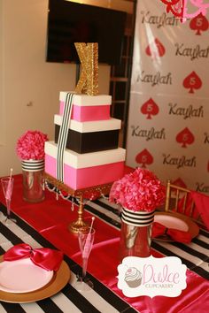 the table is decorated with pink flowers and black and white stripes