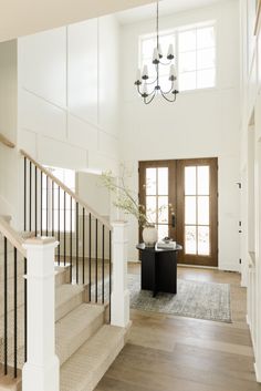 an image of a house with stairs and chandelier