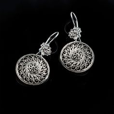 Indulge in the beauty of these exquisite earrings designed with an elegant spiral flower shape. Made of 925 sterling silver, these earrings feature intricate filigree work, creating a stunning visual effect that will leave you mesmerized. Measuring 1.80 inches in length, with a drop length of 0.90 inches and a width of 0.90 inches, these earrings are the perfect size for everyday wear or special occasions. They are oxidized to give them a unique and antique look, and highly polished for a brilli Silver Round Earrings, Spiral Flower, Drop Earrings Silver, Oyster Bay, Filigree Jewelry, Handcrafted Art, Sterling Silver Filigree, Silver Filigree, Round Earrings