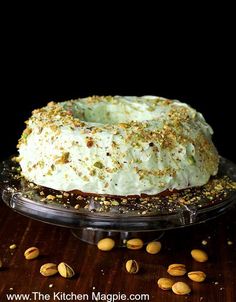 a cake sitting on top of a glass plate covered in frosting and sprinkles