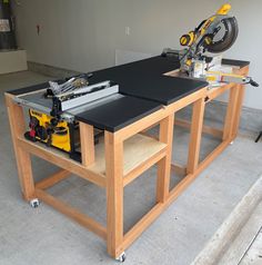 a workbench with a table saw and tools on it