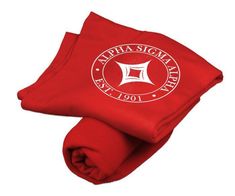 a red blanket with the logo of an emblem on it, and two matching blankets