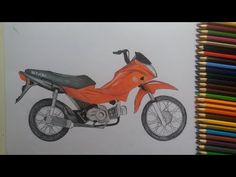 a drawing of a motorcycle on paper with colored pencils in front of the image