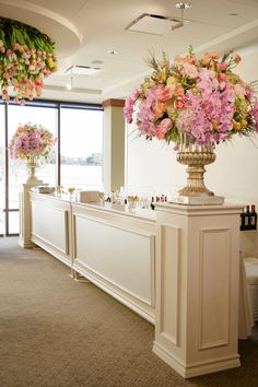 the flowers are in vases on the bar at the reception room's reception