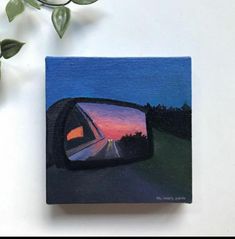 a painting of a car's side view mirror with the sun setting in the background