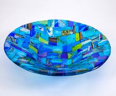 a blue glass bowl sitting on top of a white table