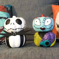 three halloween pillows sitting on top of a couch