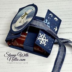 an ornament in a blue box with snowflakes on it