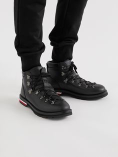 Moncler's boots are inspired by traditional hiking styles and made from leather that will wear well. They have rubber soles that are substantial but not bulky, and are finished with the signature tricolour stripes as a nod to the brand's heritage. Wear it with: Moncler Jacket, Prada Sweater, Dolce & Gabbana Sweatpants, Moncler Scarf. Lace-up Calf Leather Boots With Vibram Sole, High-top Lace-up Boots With Vibram Sole In Calf Leather, Leather Sole Ankle Hiking Boots, Winter Lace-up Boots With Rubber Sole In Calf Leather, Calf Leather Lace-up Boots With Vibram Sole, High-top Combat Boots With Vibram Sole In Calf Leather, High Ankle Leather Waterproof Boots With Vibram Sole, Winter Calf Leather Lace-up Boots With Lug Sole, Winter Lace-up Boots With Lug Sole And Calf Leather