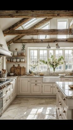 a kitchen filled with lots of counter top space and white cabinets next to a window