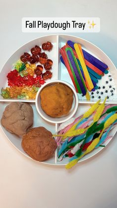 a white plate topped with different types of food on top of a table next to candy