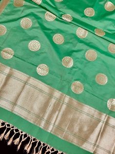 Beautiful Green Color Handmade Dupatta with Chakra design and floral design on the borders. Super Light weight and very easy to carry. Can be worn with a Suit or lehenga easily. Item: DupattaBase color : Light Green Color Zari Work : Gold Fabric : Premium quality Banarasi Soft Silk (Non-Pure)Work : Zari Weaved with tasselsLength of the dupatta : 92 inches Width of the dupatta : 37 inches Store Policies - No return or exchange will be accepted for color variations. - No return or exchange will be Men's Ethnic Wear, Bandhani Saree, Kantha Stitch, Readymade Blouse, Gold Fabric, Cotton Silk, Cotton Linen, Light Green, Party Wear