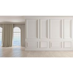 an empty room with white walls and wooden floors