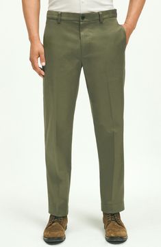 Classic and versatile, these chinos tailored from soft cotton feature a traditional flat front and a touch of stretch to keep you moving comfortably. 15 1/2" leg opening Zip fly with button closure Side pockets; back button-welt pockets 97% cotton, 3% spandex Machine wash, tumble dry Imported Green Pants Men, Pants Green, Half Zip Sweaters, Striped Polo Shirt, Stretch Chinos, Green Pants, Chino Pants, Supima Cotton, Oxford Shirt