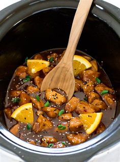 a slow cooker filled with chicken and oranges