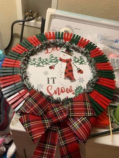 a christmas wreath with the words it's snow on it