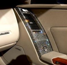 the interior of a luxury car with sparkling dashes on it's trims