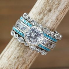 a stack of rings with blue and white stones