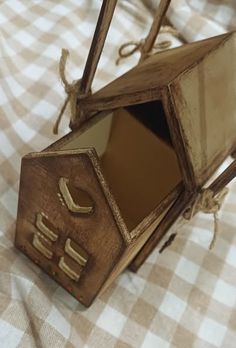 an open wooden box sitting on top of a checkered table cloth