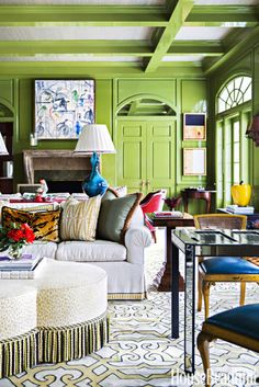 a living room filled with furniture and green walls