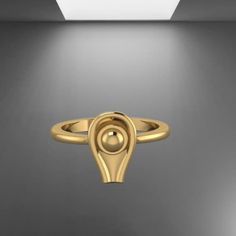 a gold ring is shown in the middle of a room with light coming from it