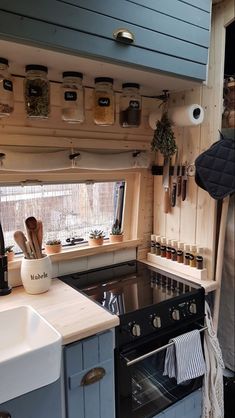 a kitchen with a stove top oven next to a window