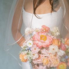 a bride holding a bouquet of flowers in her hands