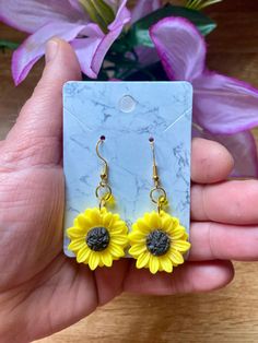 💫Come visit my shop!💫    --Cosmic CrysDals--        https://cosmiccrysdals.etsy.com Whimsical Sunflower 🌻 Earrings  Sunflower resin charm with yellow glass accent bead on gold rings -925 silver plated gold wires Yellow Hypoallergenic Flower-shaped Earrings, Yellow Sunflower Dangle Earrings, Yellow Sunflower Design Dangle Earrings, Cute Yellow Flower Shaped Jewelry, Yellow Flower Jewelry With Matching Earrings, Yellow Sunflower Design Flower Earrings, Yellow Dangle Flower Earrings As Gift, Yellow Dangle Flower Earrings For Gift, Handmade Yellow Drop Flower Earrings