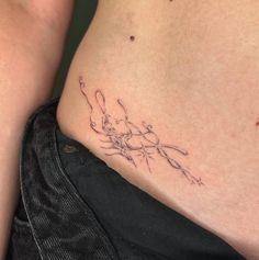 a tattoo on the side of a woman's stomach