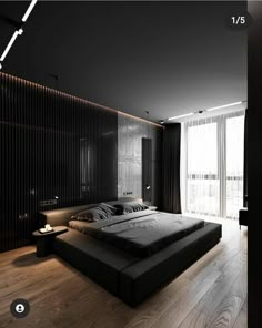 a large bed sitting in the middle of a bedroom next to a wooden floor and wall