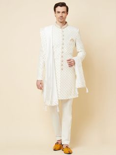 This Royal White Embroidered sherwani will instantly give an elegant look. Made from polyester cotton fabric, this 3 piece sherwani set features a white royal sherwani, front buttons fastening, designer cuff buttons, pocket square, and a mandarin collar. This white base sherwani has beautiful subtle gold Jaal thread-sequin embroidery work all over. It is paired with white churidar pants and matching dupatta. An ideal outfit for traditional & special events.

Size Chart For Men





	
	
					Men' White Nehru Jacket With Traditional Drape For Groom, White Nehru Jacket For Groom With Traditional Drape, Elegant White Cotton Churidar, White Kurta With Zari Work For Groom, White Zari Work Kurta For Groom, White Bandhgala For Groom With Traditional Drape, Elegant Cotton Sherwani For Wedding, White Traditional Wear With Resham Embroidery For Groom, White Resham Embroidery Traditional Wear For Groom