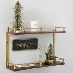 a shelf that has some christmas decorations on top of it and a candle in the middle