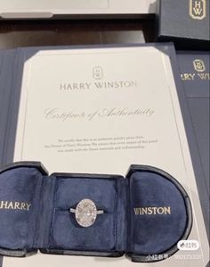 an engagement ring sits in its presentation box