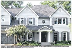 a large white house with lots of windows and shutters on the front door is featured in this article