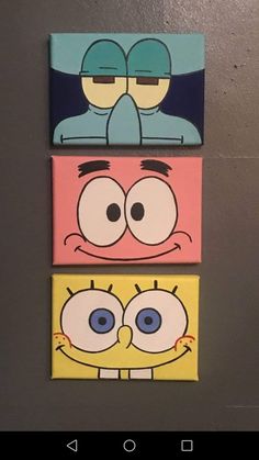 three cartoon characters painted on canvases mounted to the wall in a room with grey walls