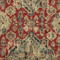 an old rug with red and blue colors