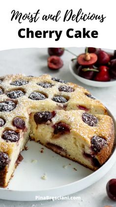 a close up of a cake on a plate with cherries in the background and text overlay